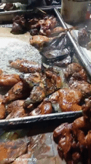 Night street food vendors serve grilled meat near convenience store