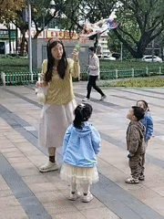 Woman blows bubbles for children in Yuzhong District