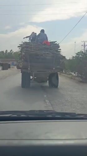 Mixed traffic flows through Sikandar Khel on cloudy morning