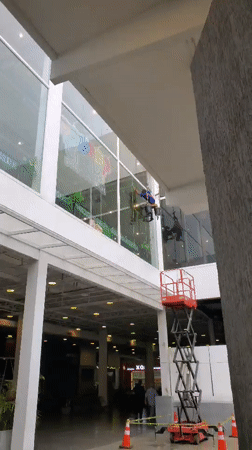 Window cleaners work on building in Cabudare, Venezuela