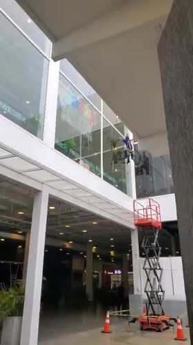 Window cleaners work on building in Cabudare, Venezuela