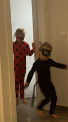 Children in costumes play outside Valencia building