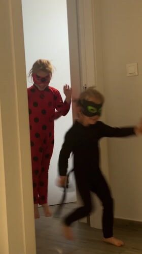 Children in costumes play outside Valencia building
