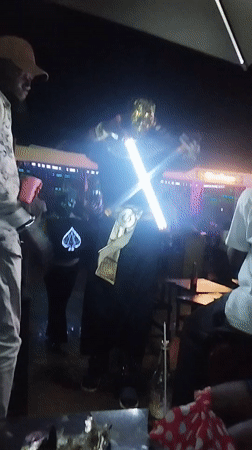 Nighttime gathering at outdoor venue in Tumfure, Nigeria