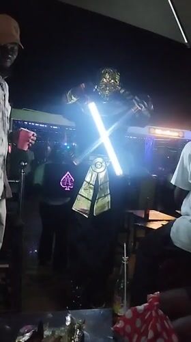 Nighttime gathering at outdoor venue in Tumfure, Nigeria