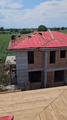 Residential construction underway in rural area amid green fields