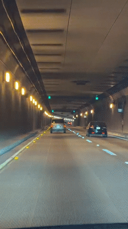 Driving through a lit tunnel in Oakland at night