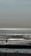 Surfers gather on a Tenerife beach on a July afternoon