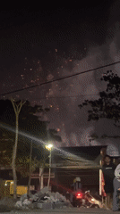 Fireworks over Malang with street-level activity below