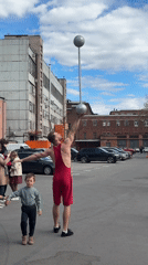 Street circus performers entertain crowds in Saint Petersburg parking lot