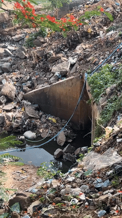 Daily life documented in Guzape: car washing, polluted drains