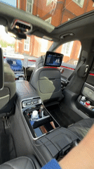 Luxury car interior and numbered brick building documented in Russia