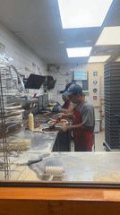 Late-night pizza preparation in Arica commercial kitchen