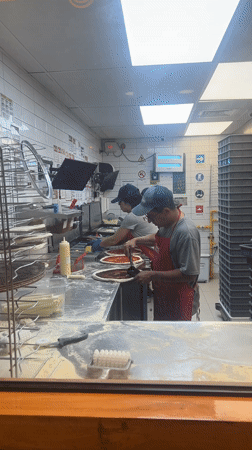 Late-night pizza preparation in Arica commercial kitchen