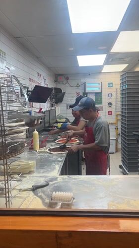 Late-night pizza preparation in Arica commercial kitchen
