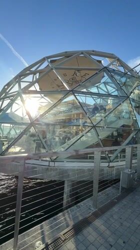 San Diego waterfront: dome, sailboat, and patio at sunset