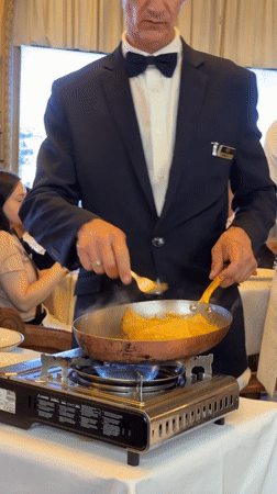 Waiter Alain performs tableside service at upscale Paris restaurant
