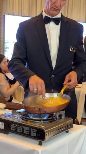 Waiter Alain performs tableside service at upscale Paris restaurant