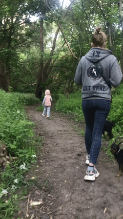 Family walks dogs through Kharkiv forest during afternoon outing