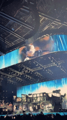 Stadium concert with elaborate stage and packed crowd