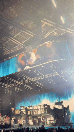 Stadium concert with elaborate stage and packed crowd