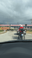 Motorcyclist waits at railroad crossing in Sandanski, Bulgaria