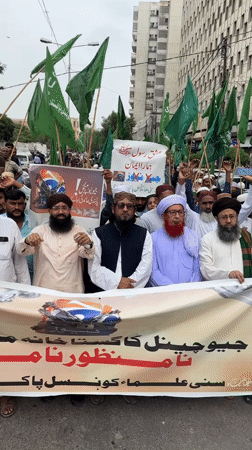 Religious procession marches through Karachi with flags and protest banners