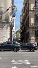 Film crew shoots on narrow Barcelona street with crane
