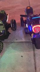 Electric toy cars line outdoor plaza in Mui Ne