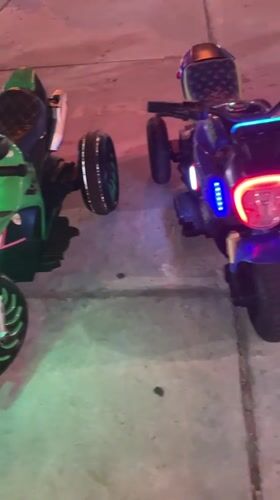 Electric toy cars line outdoor plaza in Mui Ne