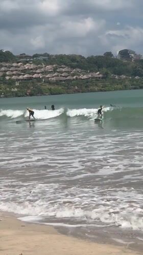 Early morning surfing session captured at Kuta Selatan beach