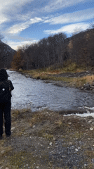 Ushuaia residents document river scene, construction equipment