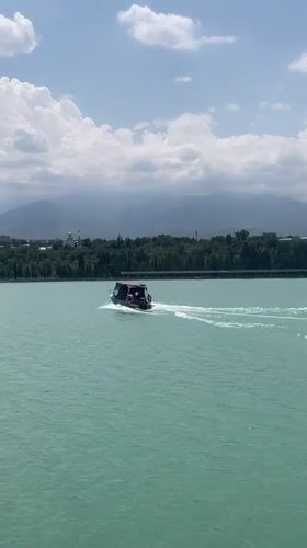 Almaty's lakefront park on a busy summer morning