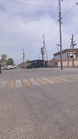 White mosque observed on busy street corner in Syrdarya