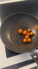 Cherry tomatoes cooked in frying pan in London