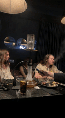 Young women enjoy hookah dining experience in Izhevsk restaurant