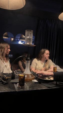 Young women enjoy hookah dining experience in Izhevsk restaurant