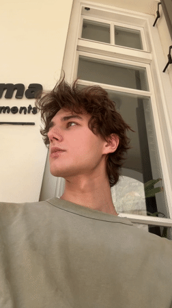 Young man observed outside white building in Tel Aviv