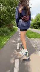Skateboarding through a Krasnoyarsk park path on a summer morning