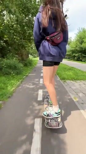 Skateboarding through a Krasnoyarsk park path on a summer morning