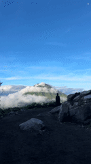 Hikers traverse Indonesian mountain trail during evening hours