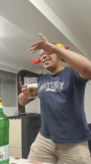Person in jester hat celebrates with beer in Damianovo