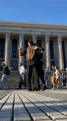 Tango dancers perform in front of classical Buenos Aires building