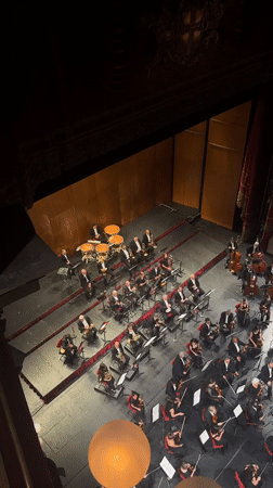 Orchestra performs at Milan theater amid evening city activities