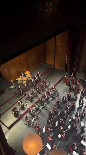 Orchestra performs at Milan theater amid evening city activities