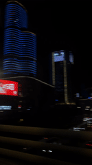 Night cityscape filmed from moving vehicle in Liangjiang, China