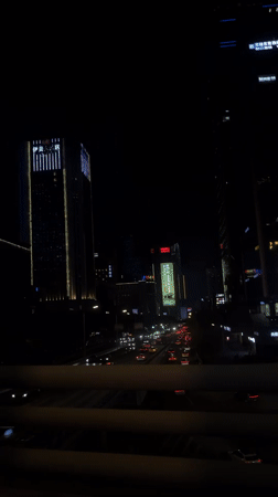 Night cityscape filmed from moving vehicle in Liangjiang, China