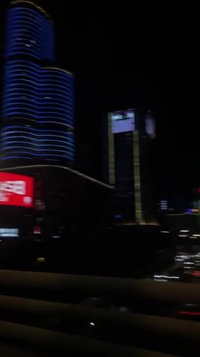 Night cityscape filmed from moving vehicle in Liangjiang, China