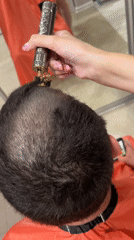 Person Gets Haircut with Decorative Trimmer in Irkutsk