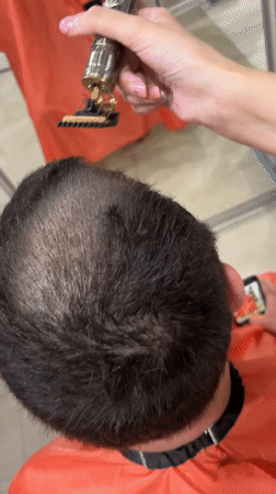 Person Gets Haircut with Decorative Trimmer in Irkutsk